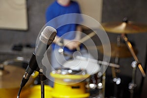 Microphone in studio. drummer in out of focus