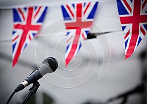 Microphone and union jack bunting at one of the concert stands at Garth Park, Bicester