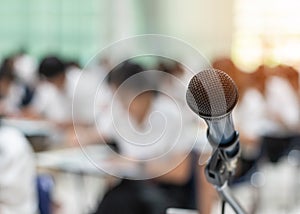 Microphone voice speaker with audiences or students in seminar classroom, lecture hall or conference meeting in educational