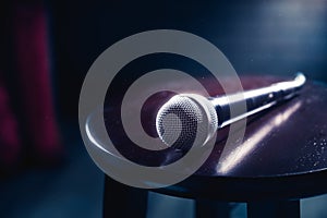 Microphone on a wood stool on a stage