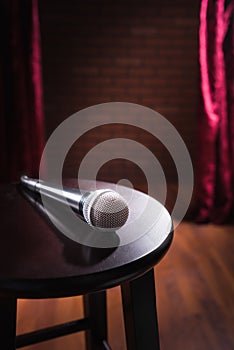 Microphone on a wood stool on a stage