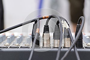 Microphone xrl connectors pluged in a audio mixing console