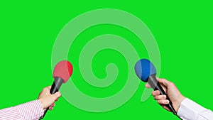 Microphones in the hands of journalists for interview on green screen background. Conference meeting microphones