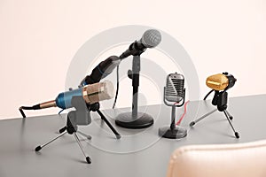 Microphones on light grey table in hall. Journalist`s work