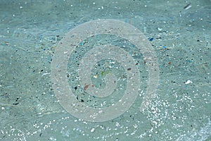 microplastic particles float in the ocean, water pollution