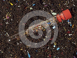 Microplastics in soil a test tube with soil sample photo