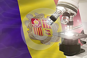 Microscope on Andorra flag background - science development concept. Research in medicine or nanotechnology 3D illustration of