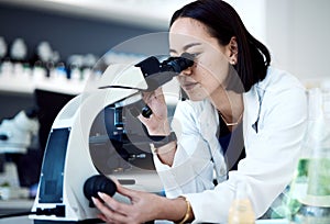Microscope, Asian woman and in laboratory for research, innovation and science method for healthcare. Female researcher