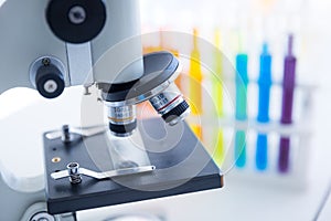 Microscope with a colorful test tube in the laboratory.