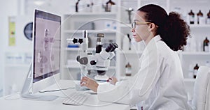 Microscope, computer and science black woman typing results, data and research for medical innovation, investigation and