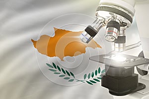 Microscope on Cyprus flag background - science development concept. Research in genetics or healthcare 3D illustration of object