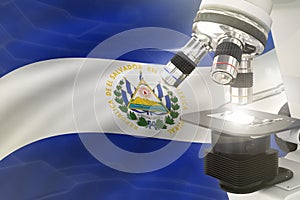 Microscope on El Salvador flag background - science development concept. Research in genetics or cell life 3D illustration of