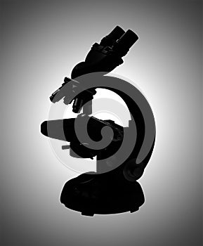 Microscope in gray silhouette, isolated