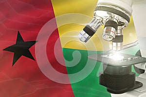 Microscope on Guinea flag background - science development concept. Research in medicine or nanotechnology 3D illustration of