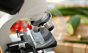 Microscope head on kitchen background