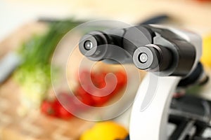 Microscope head on kitchen background