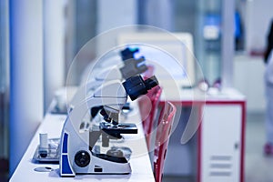 Microscope in laboratory table on blur background