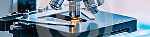 Microscope with metal lens at laboratory. Scientific and healthcare research, examining of test sample in a lab