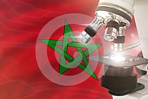 Microscope on Morocco flag background - science development concept. Research in pharmaceutical industry or cell life 3D