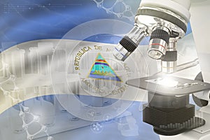 Microscope on Nicaragua flag - science development digital background. Research of nanotechnology design concept, 3D illustration