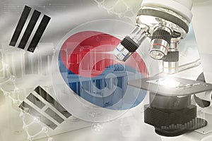 Microscope on Republic of Korea South Korea flag - science development digital background. Research of nanotechnology design