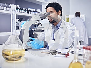 Microscope, scientist and black man with research, healthcare and diagnosis in laboratory. Science, African American