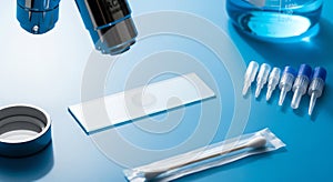 Microscope, Slides, and Laboratory Equipment on Blue Surface