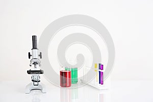 Microscope, test tubes and beakers. Conceptual image