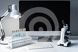 microscope and test tubes with liquid