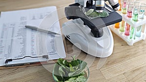 Microscopes and experimentation with plant leaves in a laboratory