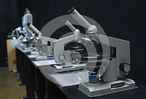 Microscopes set on the worktable of the school lab