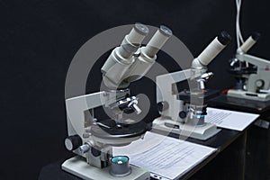 Microscopes set on the worktable of the school lab