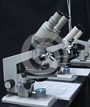 Microscopes set on the worktable of the school lab