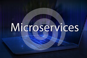 Microservices text on blue technology background with laptop