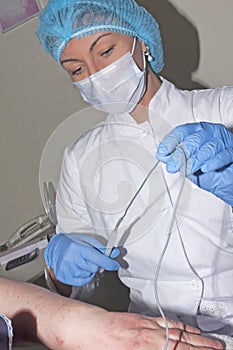 Microsurgery: Dermatologist doctor prepares the electro coagulator