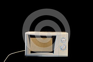 Microwave against black background