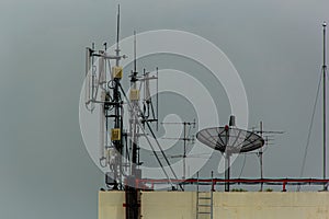 Microwave antenna tower on blue sky background