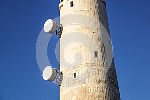 Microwave antenna on the wall of building.