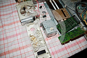 Microwave oven disassembled on a kitchen table