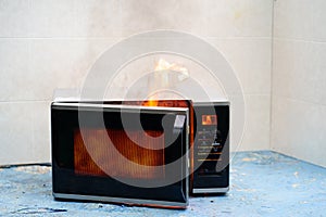 microwave oven on fire. the concept of fire in the kitchen.