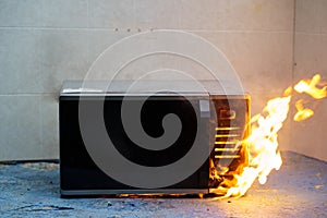 microwave oven on fire. the concept of fire in the kitchen.