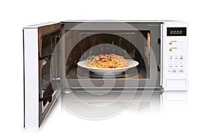 The microwave oven is warm chicken spaghetti.