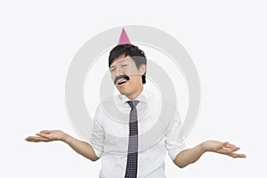 Mid adult businessman shrugging his shoulders over white background