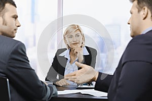 Businesswoman concentrating at meeting photo