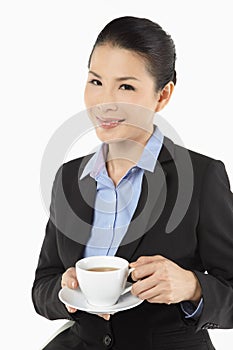 Mid adult businesswoman drinking coffee. Conceptual image
