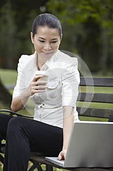 Mid adult businesswoman working while drinking coffee. Conceptual image