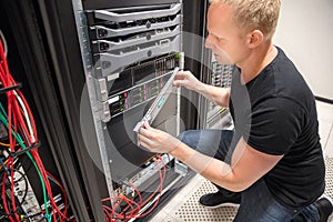 Engineer Checking Computer Server In Datacenter