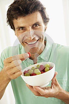 Mid Adult Man Eating Fresh Fruit