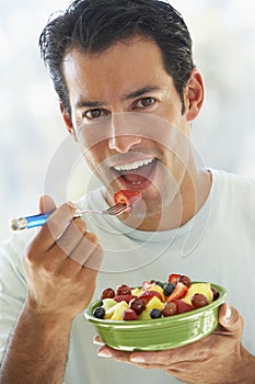 Mid Adult Man Eating Fresh Fruit Salad