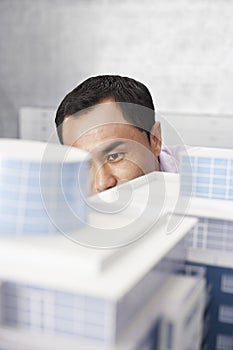 Mid adult man looking at architectural model close-up